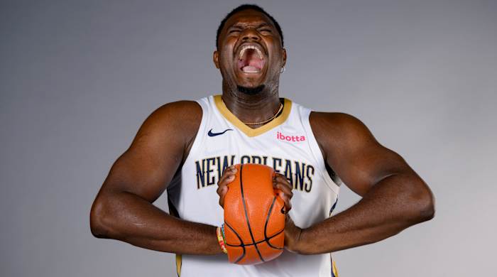 New Orleans Pelicans forward Zion Williamson crushes a basketball while posing during Pelicans’ NBA media day.